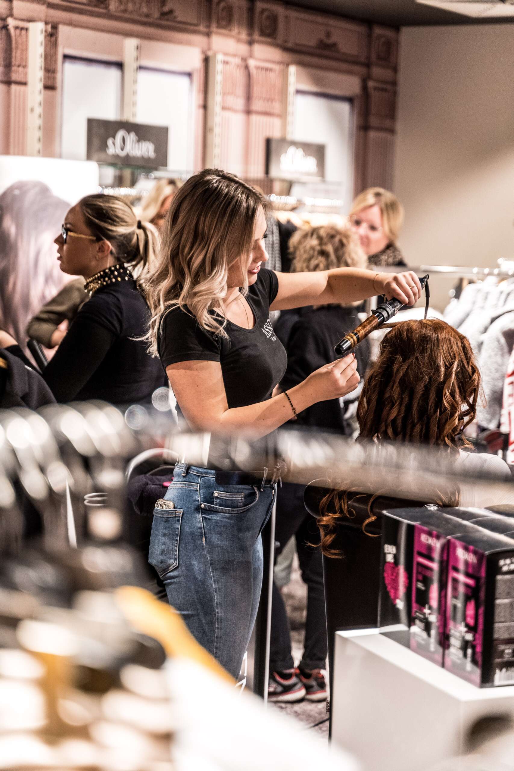 Woman Cutting hair, Hair Salon is using is iPos Retail POS