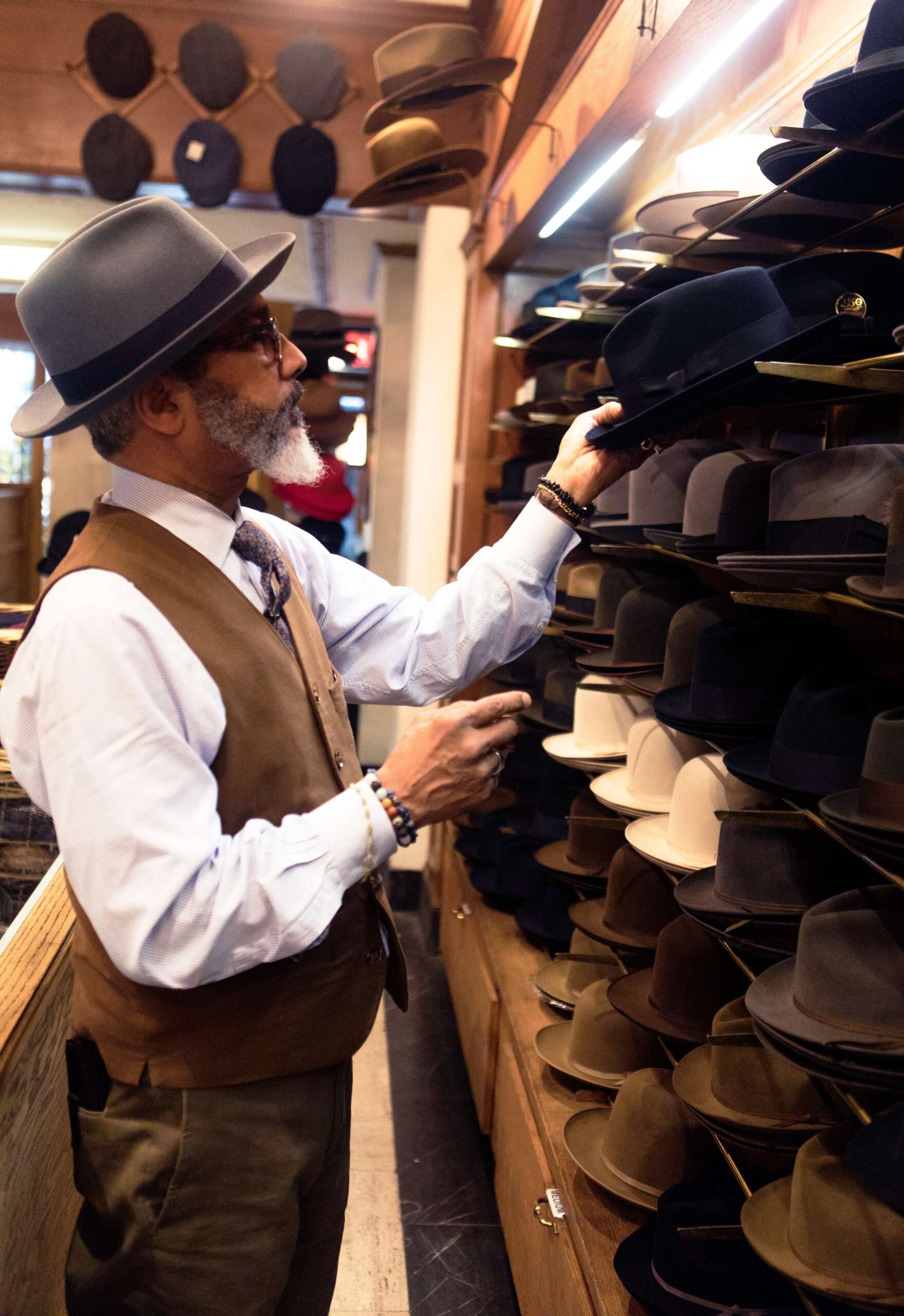 Person choosing a hat to wear, the hat store is currently using iPos as its Retail POS